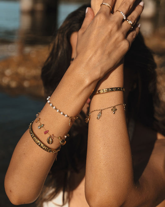 Multiple bracelets, Australian jewellery. Stainless steel rings with PVD 18k gold Plated. Shell rings and freshwater pearl rings. Waterproof jewellery Australia, Cuff with ocean animals and chain bracelet with seahorses, palm tree, star, fish and shell charms