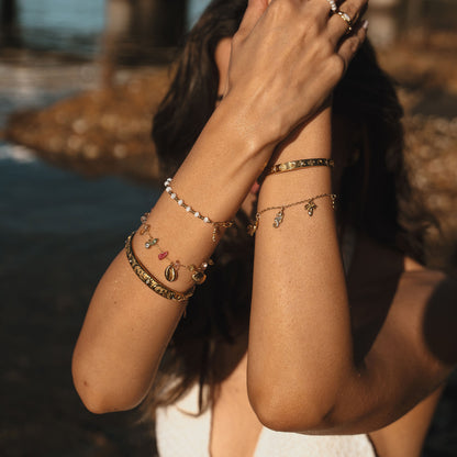 Gold bracelet with a sunflower charm on a white background. Stainless steel waterproof sheel beads, Stainless steel 18k PVD Gold Plated. Waterproof jewellery. Australian jewellery. ocean inspired jewellery.