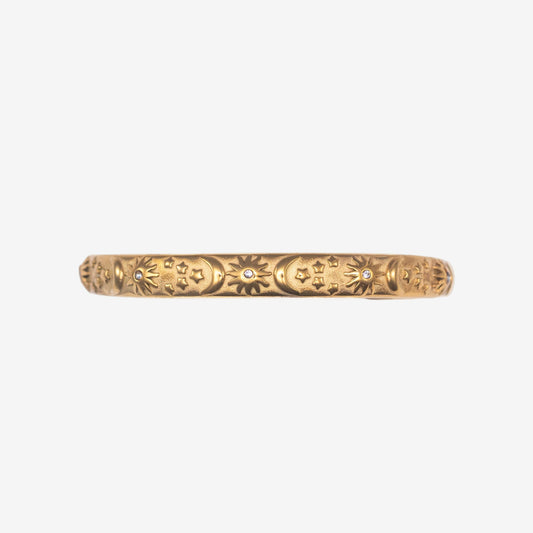 Gold bracelet with intricate designs on a white background