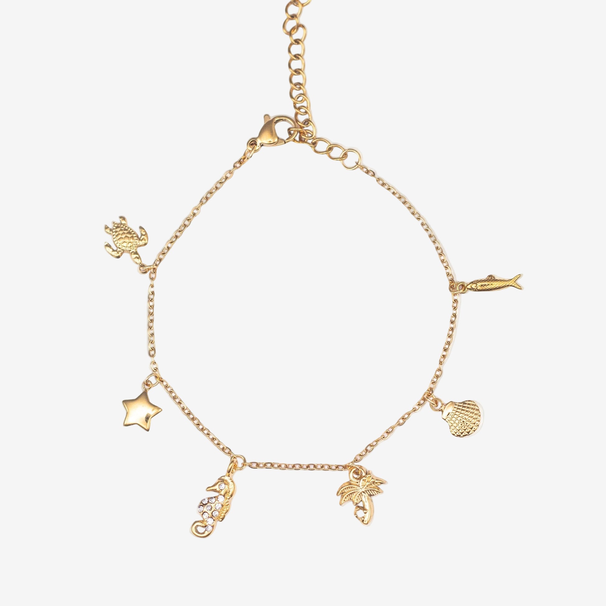 Gold bracelet with various ocean charms on a white background. Turtle, Star, seahorse, Palm tree, shell and fish charms. Stainless steel 18k PVD Gold Plated. Waterproof jewellery. Australian jewellery. ocean inspired jewellery