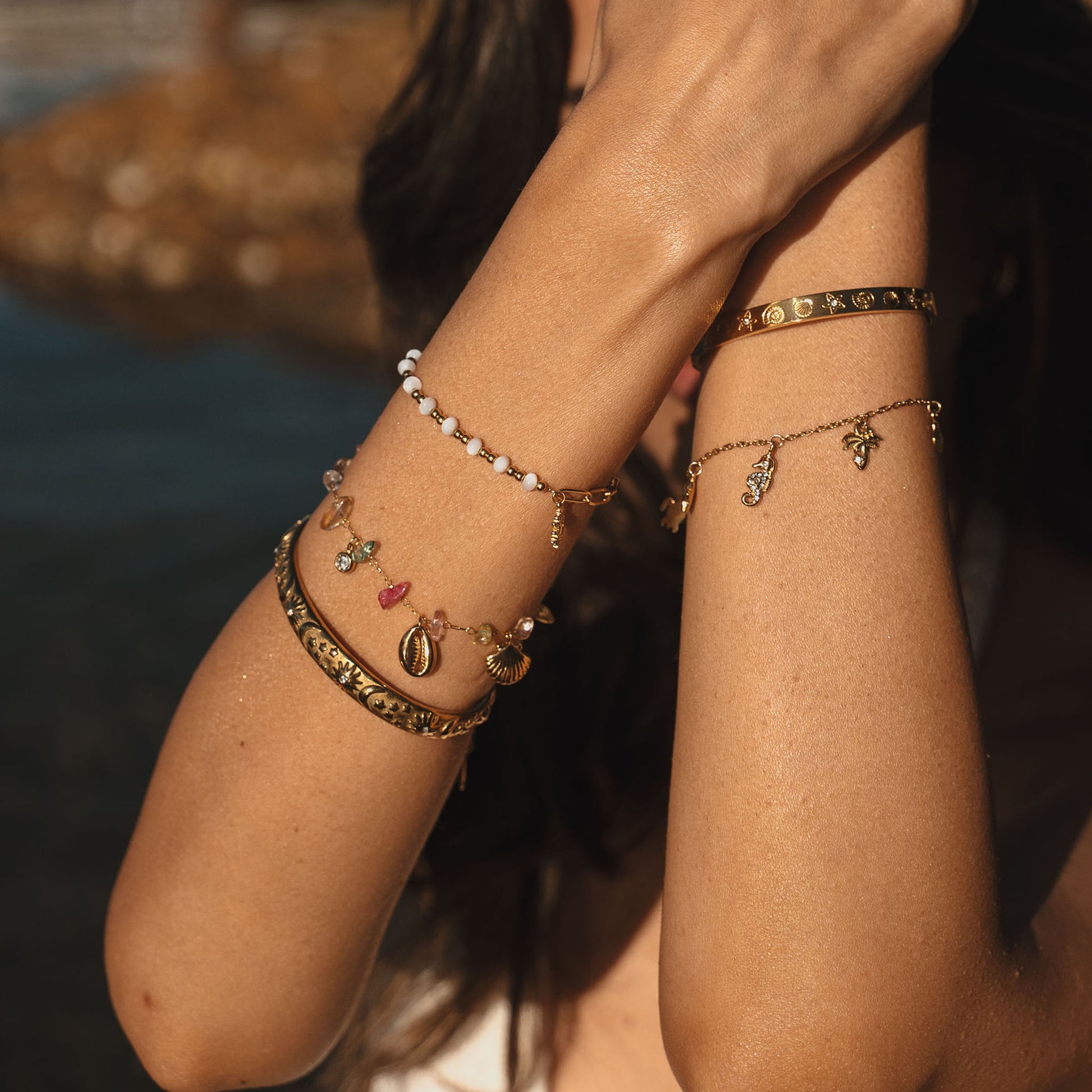 Gold bracelet with a sunflower charm on a white background. Stainless steel waterproof sheel beads, Stainless steel 18k PVD Gold Plated. Waterproof jewellery. Australian jewellery. ocean inspired jewellery.